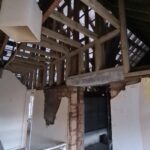 Internal view showing stripped walls and ceilings across ground and first floors with structural elements exposed