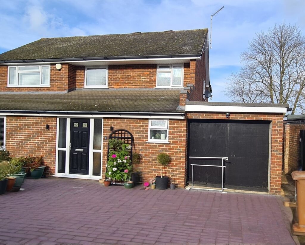 Before image of a detached house in Hatfield showing the original single garage prior to conversion