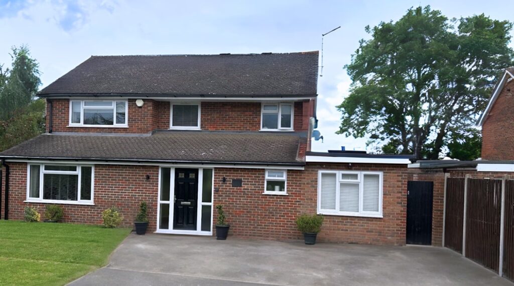 Single garage conversion in Hatfield with new windows replacing the garage door, creating a home office and guest suite.