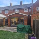 Finished rear extension viewed from the garden with large glazed doors opening into the family space