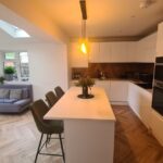 Internal view of the finished extension showing family seating area and kitchen within a bright open-plan layout